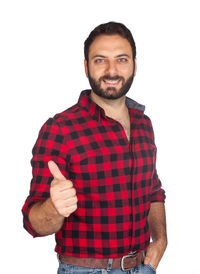 Portrait of young man standing against white background