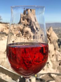 Close-up of red wineglass on glass