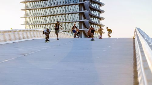 Group of people skateboarding on elevated road