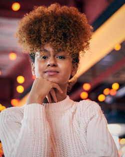 Portrait of young woman with curly hair at restaurant