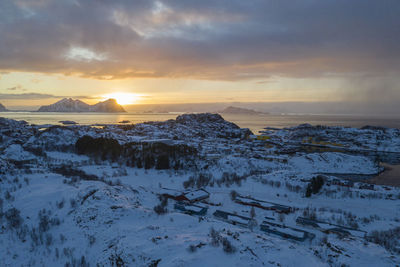 Scenic view of snow covered mountains against sky during sunset