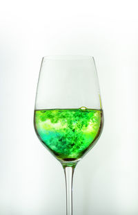 Close-up of wine in glass against white background