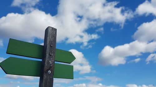 Low angle view of road sign against sky