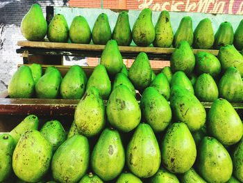 Green fruits for sale at market stall