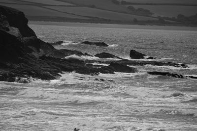 Scenic view of rocks in sea against sky