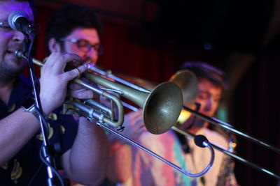 Musicians playing musical instruments while standing on stage