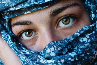 Close-up portrait of woman with covered face