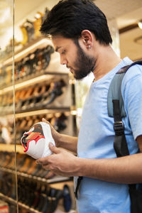 Man choosing shoes in market