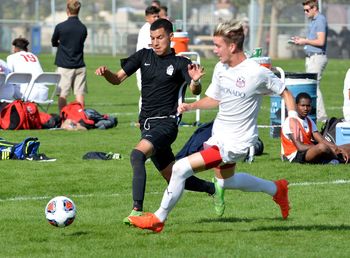 Men playing soccer on field