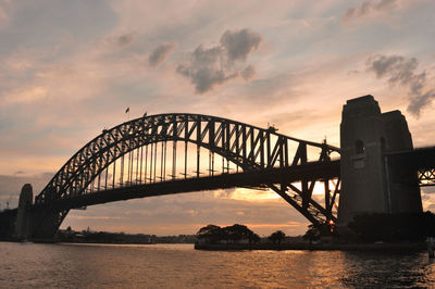 View of bridge over river against cloudy sky