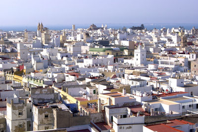 High angle view of white spanish townscape against sky. cadiz, spain