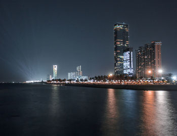 Illuminated city at waterfront