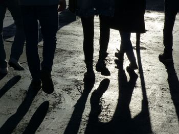 Low section of silhouette people against blurred background