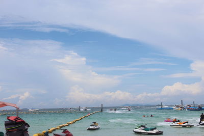 People on sea against sky