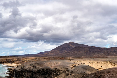 Scenic view of arid landscape against sky