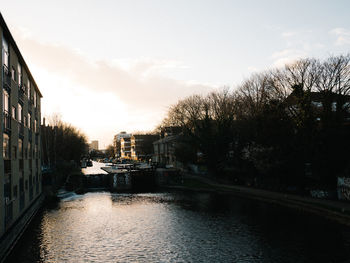 Canal amidst buildings against sky