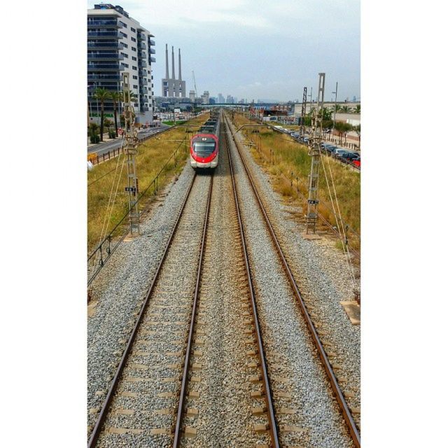 railroad track, transportation, building exterior, rail transportation, the way forward, built structure, architecture, diminishing perspective, city, public transportation, vanishing point, high angle view, mode of transport, railroad station platform, railroad station, sky, auto post production filter, day, transfer print, railway track