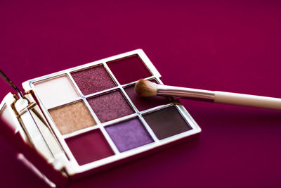 Close-up of beauty products against yellow background