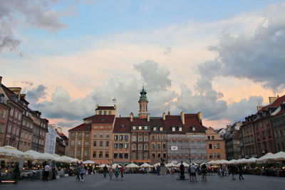 People in town square against sky