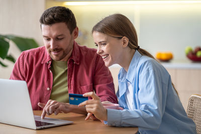 Side view of man using digital tablet at home