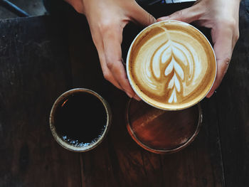 Midsection of coffee cup on table