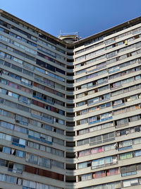 Low angle view of modern building against blue sky