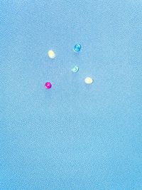 High angle view of multi colored pencils over blue background