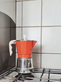 Close-up of coffee pot on gas stove at home