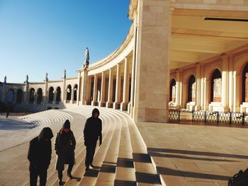 Group of people walking in front of building