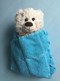 Close-up of stuffed toy covered with towel on table