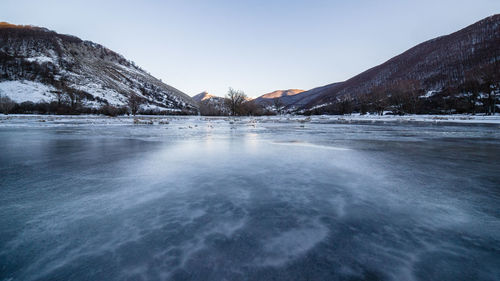 Scenic view of frozen lake against clear sky