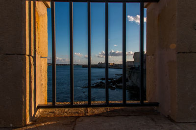 Sea seen through railing of building