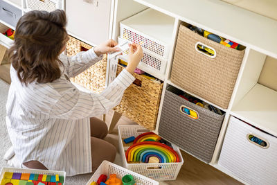 Rear view of girl playing with teddy bear