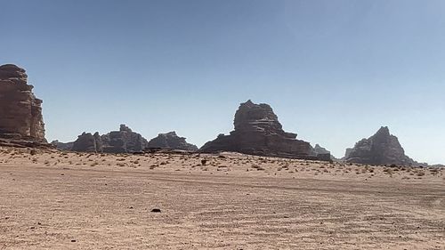 Rock formations on landscape against clear sky