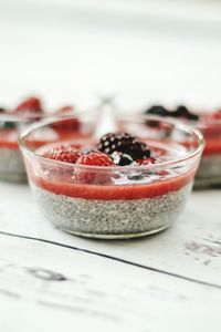 Healthy dessert with chia seeds in transparent bowl