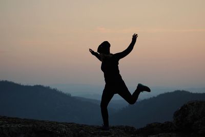 Silhouette of woman at sunset