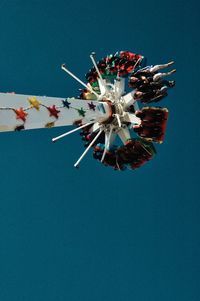 Low angle view of ferris wheel against blue sky