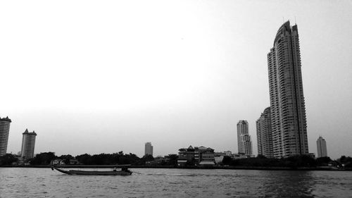 Modern buildings in city against clear sky