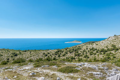 Scenic view of sea against clear blue sky