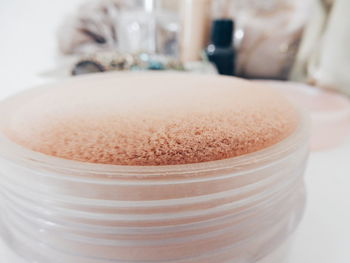 Close-up of powder puff in powder compact on table