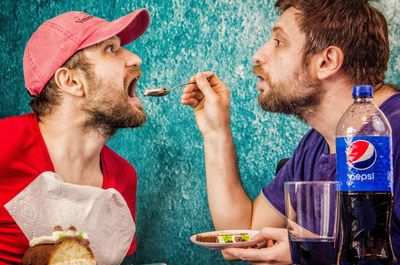 Two men eating food