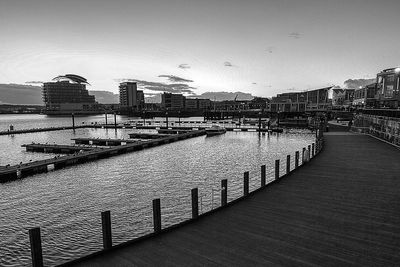 River by buildings against sky in city