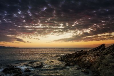 Scenic view of sea against cloudy sky