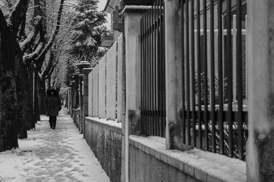 Man walking on cobblestone street in city