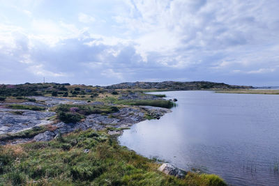Scenic view of sea against cloudy sky