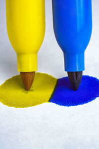 High angle view of yellow drinking glass on table