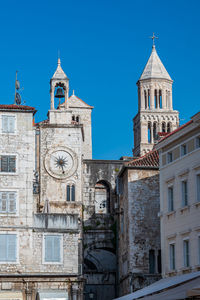 Low angle view of historic building against clear blue sky