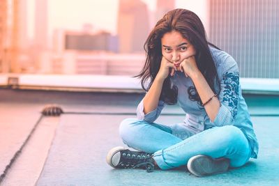 Portrait of young woman sitting outdoors