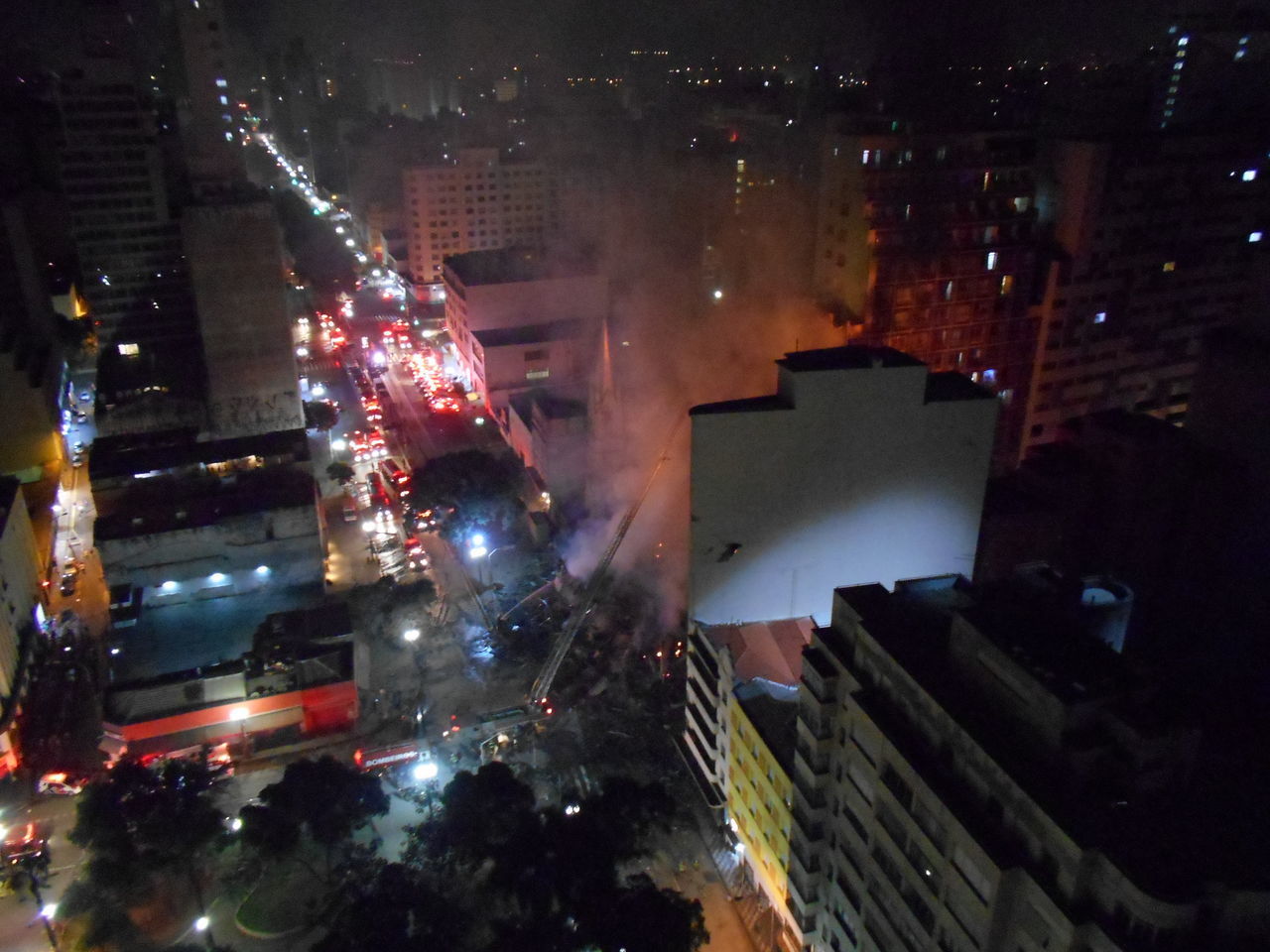 HIGH ANGLE VIEW OF ILLUMINATED BUILDINGS AT NIGHT