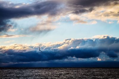 Scenic view of sea against storm clouds